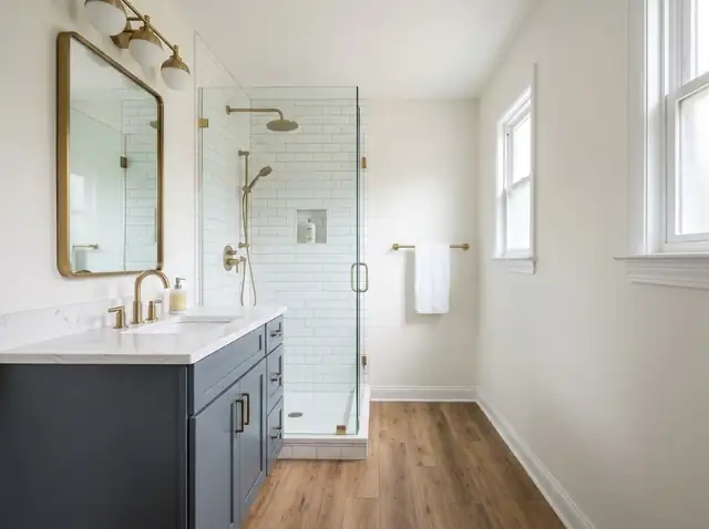 Illustration of a remodeled bathroom with a gray shaker vanity, white quartz top and white tile shower